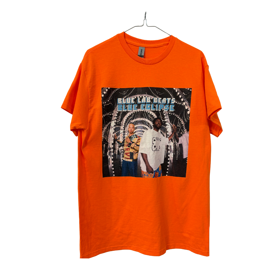 Orange t-shirt with graphic design of two people and text 'Blue Lab Beats Blue Eclipse' Cover art of Blue Lab Beats forth album on white background.